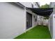 Backyard features artificial turf, awning, outdoor chairs, and privacy fence at 403 S Fremont Ave # 3, Tampa, FL 33606