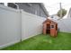 Backyard features artificial turf, modern fence and wooden playhouse at 403 S Fremont Ave # 3, Tampa, FL 33606
