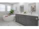 Elegant bathroom with soaking tub, double vanity, and marble tile flooring at 403 S Fremont Ave # 3, Tampa, FL 33606