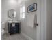 Stylish half bath with vanity, patterned tile floor, and contemporary mirror at 403 S Fremont Ave # 3, Tampa, FL 33606
