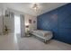 Charming bedroom with blue accent wall, a cozy bed, and stylish decor at 403 S Fremont Ave # 3, Tampa, FL 33606