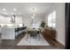 Dining room area adjacent to a modern kitchen, featuring stylish chandelier and decor at 403 S Fremont Ave # 3, Tampa, FL 33606