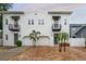 Charming two-story white home featuring stylish black awnings and a brick driveway at 403 S Fremont Ave # 3, Tampa, FL 33606