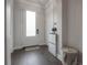 Bright foyer with hardwood floors, decorative globe, and a modern shoe storage cabinet at 403 S Fremont Ave # 3, Tampa, FL 33606