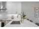Bright kitchen with stainless steel appliances, white cabinets, and stone countertops at 403 S Fremont Ave # 3, Tampa, FL 33606
