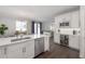 Open kitchen layout with stainless steel appliances, white cabinets and island seating at 403 S Fremont Ave # 3, Tampa, FL 33606