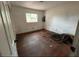 View of bedroom interior with hardwood floor, one window and exposed wiring at 4050 Iris N St, St Petersburg, FL 33703