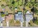 Aerial view of a fenced backyard featuring a pool, a storage shed, and mature trees at 4399 Dior Rd, Spring Hill, FL 34609