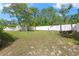 Spacious backyard with large grassy area, swing, and shed at 4399 Dior Rd, Spring Hill, FL 34609