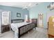 Bright bedroom with light blue walls, wood flooring, and a ceiling fan at 4399 Dior Rd, Spring Hill, FL 34609