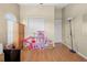 This bedroom features hardwood floors, a closet, and a play area with toys at 4399 Dior Rd, Spring Hill, FL 34609