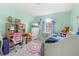 This charming bedroom is decorated with a bed, TV, dresser, and mermaid decor at 4399 Dior Rd, Spring Hill, FL 34609
