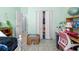 Light-filled bedroom showcasing tile floors, closet, and a corner vanity with a globe at 4399 Dior Rd, Spring Hill, FL 34609