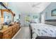 Bright bedroom with wood-look floors, blue walls, and ample natural light at 4399 Dior Rd, Spring Hill, FL 34609