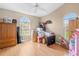 Bedroom with hardwood floors featuring boxes, stored items, and natural lighting at 4399 Dior Rd, Spring Hill, FL 34609