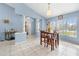 Cozy dining area featuring a wood table, chairs, tile floors, and a decorative chandelier at 4399 Dior Rd, Spring Hill, FL 34609