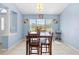 Bright dining room features neutral walls and floors, enhanced by natural light from a large window at 4399 Dior Rd, Spring Hill, FL 34609