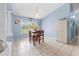 Cozy dining room with tile floors and a charming chandelier above the wooden table at 4399 Dior Rd, Spring Hill, FL 34609