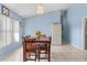 Well-lit dining room features neutral-colored walls, tile flooring, and views into other living spaces at 4399 Dior Rd, Spring Hill, FL 34609