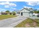 Single story home featuring an attached two-car garage with a long concrete driveway at 4399 Dior Rd, Spring Hill, FL 34609