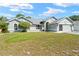Charming single-story home with well-maintained lawn, mature landscaping, and attached two-car garage at 4399 Dior Rd, Spring Hill, FL 34609