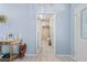 Hallway featuring a doorway into a storage room, neutral walls, and tiled flooring, creating easy access at 4399 Dior Rd, Spring Hill, FL 34609