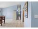 Long hallway with tile flooring connects various rooms in the house, with neutral-colored walls and bright overhead lighting at 4399 Dior Rd, Spring Hill, FL 34609