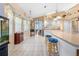 Large kitchen featuring a breakfast bar, white appliances, and open layout to other living spaces at 4399 Dior Rd, Spring Hill, FL 34609