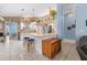 Bright kitchen with an island breakfast bar, white cabinets, and views into the adjacent dining space at 4399 Dior Rd, Spring Hill, FL 34609