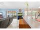 Open kitchen featuring a breakfast bar, neutral countertops, a view of the screened patio, and tile flooring at 4399 Dior Rd, Spring Hill, FL 34609