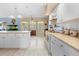 Well-lit kitchen with a breakfast bar and white appliances at 4399 Dior Rd, Spring Hill, FL 34609