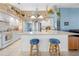 Open kitchen with a breakfast bar and stainless steel appliances, seamlessly connecting to the living area at 4399 Dior Rd, Spring Hill, FL 34609