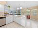 Inviting kitchen with a breakfast bar open to the living room and dining space at 4399 Dior Rd, Spring Hill, FL 34609