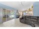 Inviting living room with sliding glass doors to the pool, a large aquarium, and tiled floors at 4399 Dior Rd, Spring Hill, FL 34609