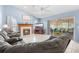 Inviting living room with a fireplace, neutral tile flooring, and sliding doors to the screened lanai at 4399 Dior Rd, Spring Hill, FL 34609