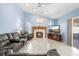 Comfortable living room features a fireplace, sliding door access to the patio, and lots of natural light at 4399 Dior Rd, Spring Hill, FL 34609