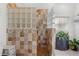 Tiled walk-in shower with glass block feature and a decorative tiled pattern at 4399 Dior Rd, Spring Hill, FL 34609