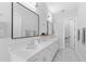 Bathroom with dual sinks, quartz countertops, and modern fixtures, showcasing a clean, contemporary design at 4515 W North A St # 6, Tampa, FL 33609