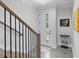 Entryway with view of front door, wood staircase with black metal railings, and a small console table at 4515 W North A St # 6, Tampa, FL 33609