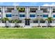 Beautiful townhome exterior with modern design, featuring a manicured lawn and palm trees at 4515 W North A St # 6, Tampa, FL 33609