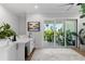 Bright flex space with a wet bar and access to a private outdoor balcony overlooking lush tropical plants at 4515 W North A St # 6, Tampa, FL 33609