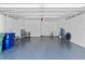 Spacious garage with epoxy floors, overhead storage racks, and ample space for vehicles and storage at 4515 W North A St # 6, Tampa, FL 33609