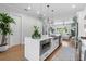 Modern kitchen island features a built-in microwave, stainless steel sink, and quartz countertops at 4515 W North A St # 6, Tampa, FL 33609
