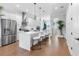 Open concept kitchen with a white island, stainless steel appliances, and hardwood floors at 4515 W North A St # 6, Tampa, FL 33609