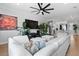 Open-concept living room with a large TV, modern furniture, hardwood floors, and stylish decor at 4515 W North A St # 6, Tampa, FL 33609