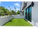 Turfed patio area with a white privacy wall and black-framed sliding glass doors to the interior at 4515 W North A St # 6, Tampa, FL 33609