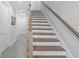 Staircase with stained treads and white risers, complemented by a white-painted stringer and wood handrail at 4515 W North A St # 6, Tampa, FL 33609