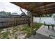 View of a backyard patio featuring a table, chairs, and a fenced-in yard space at 4705 Murray Hill Dr, Tampa, FL 33615
