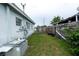 Backyard view featuring the side of the home, fencing, and the lawn area at 4705 Murray Hill Dr, Tampa, FL 33615