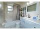 Clean bathroom featuring a shower-tub combination, updated vanity, and neutral tile flooring at 4705 Murray Hill Dr, Tampa, FL 33615